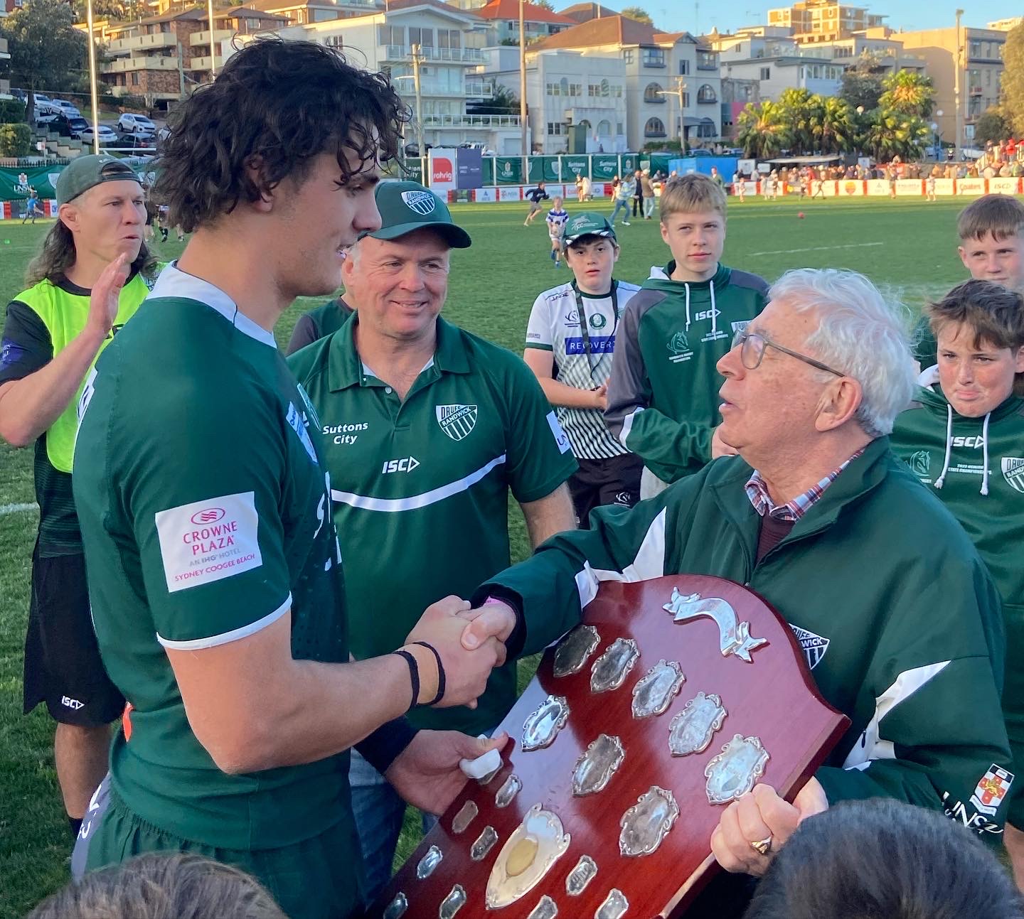 Randwick captain Ben Houston honouring Dr Joe with the club trophy
